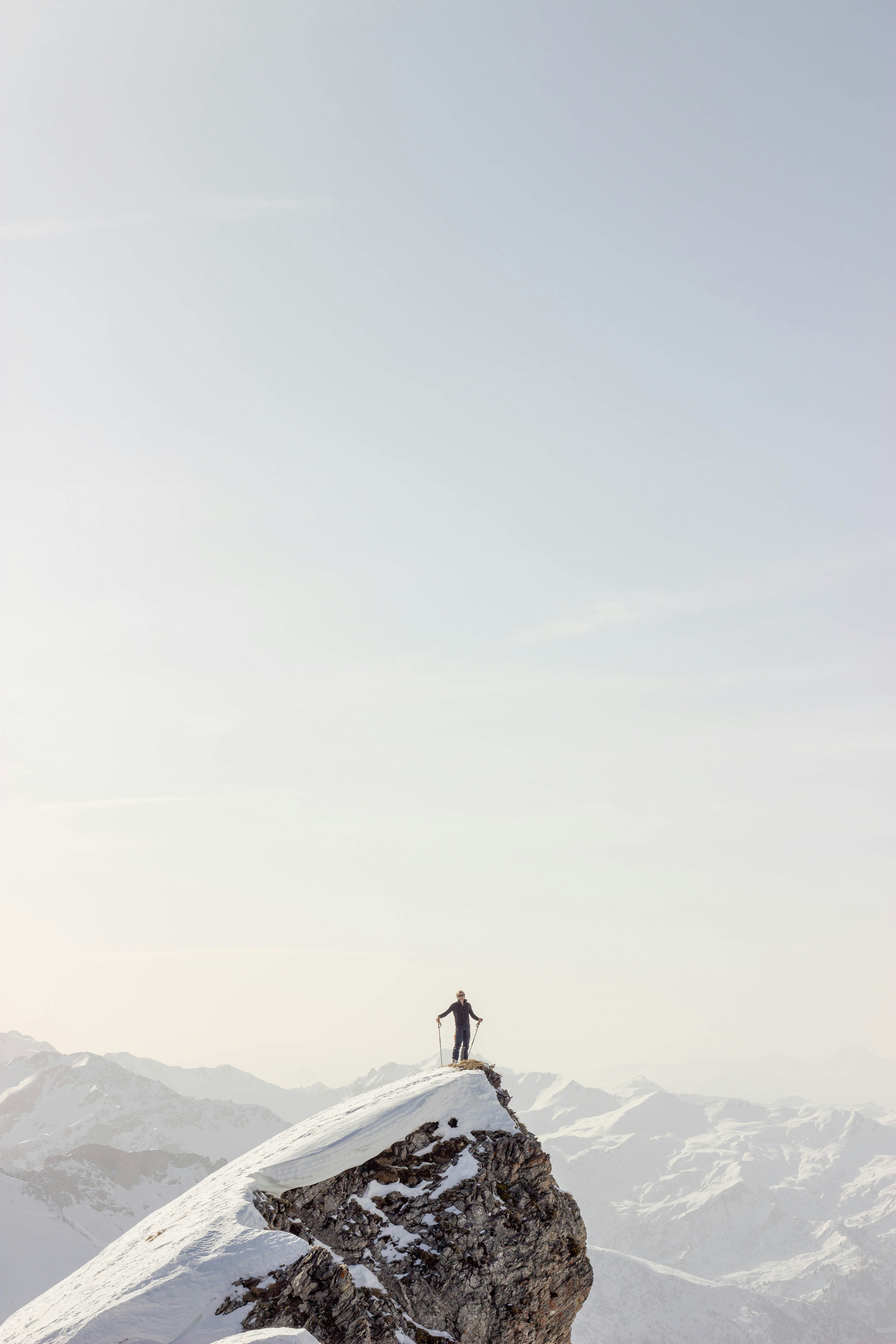 A ski tourer standing alone on a mountain ridge, illustrating a key lesson from the Skida project